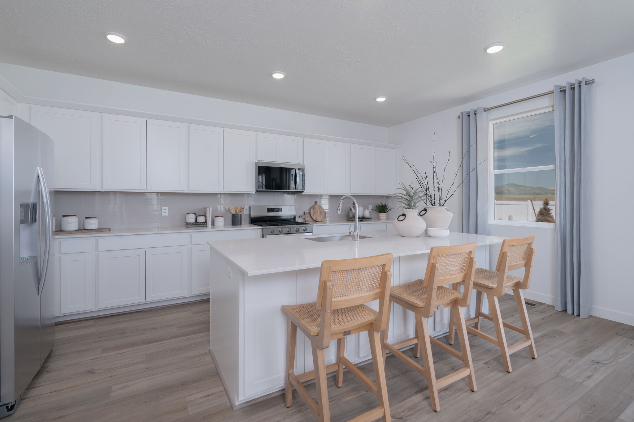 A kitchen with white cabinets.