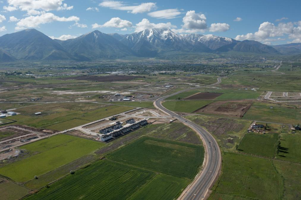 A large green landscape with mountains in the background.