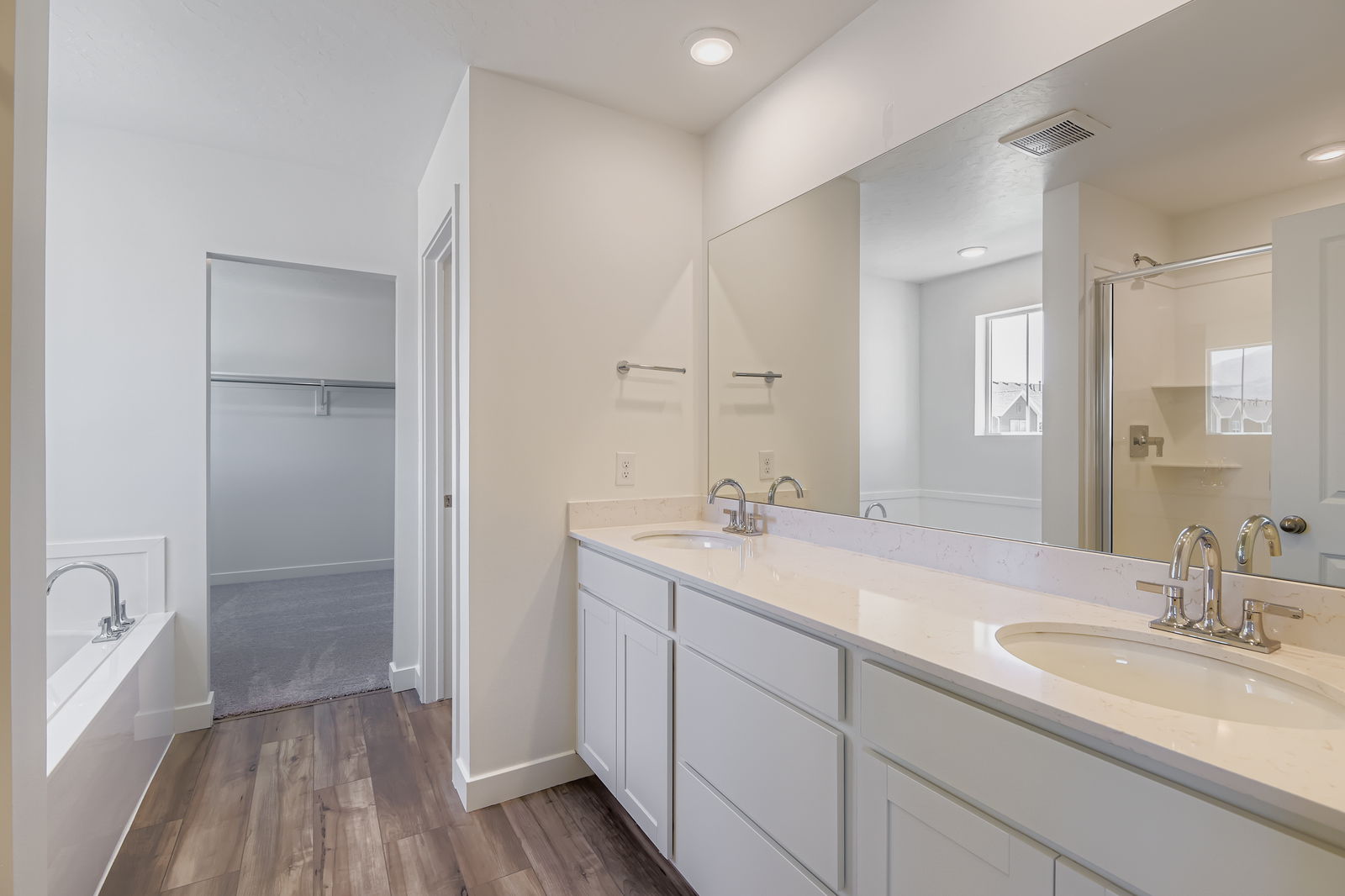 A bathroom with a large mirror.