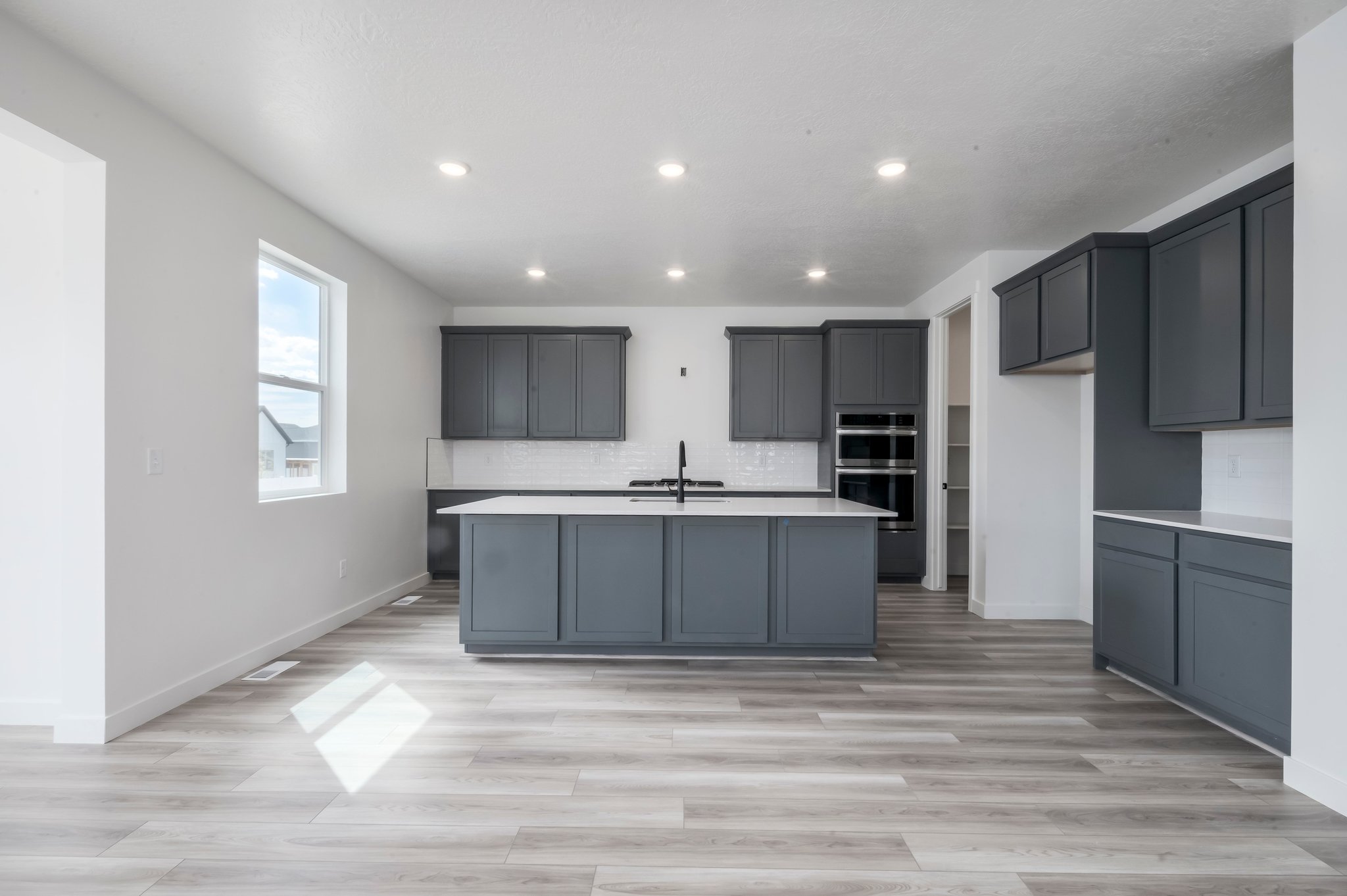 A kitchen with black cabinets.