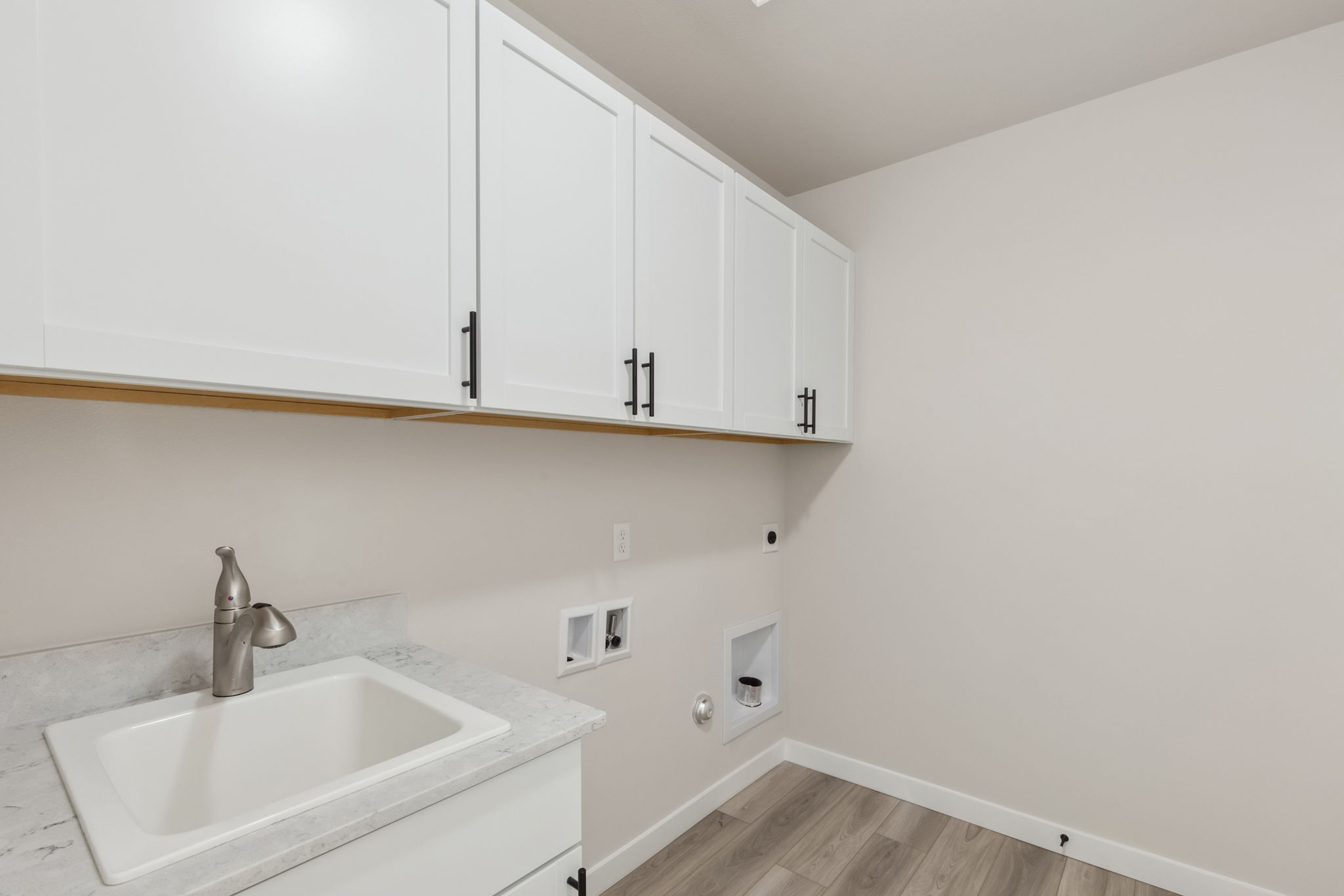 A white kitchen with white cabinets.