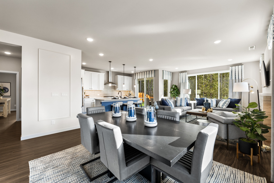 A large living room with a dining table and chairs.