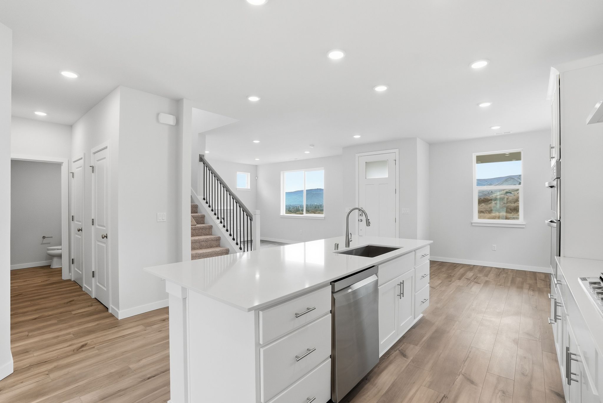 A kitchen with white cabinets.
