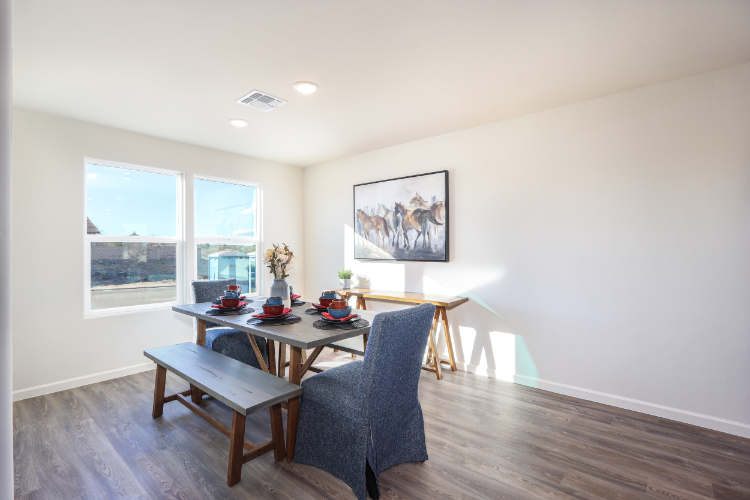 A dining room with a large window.
