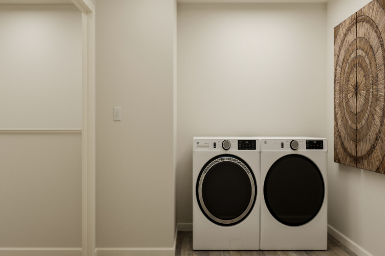 A white wall with a washing machine and a white door.