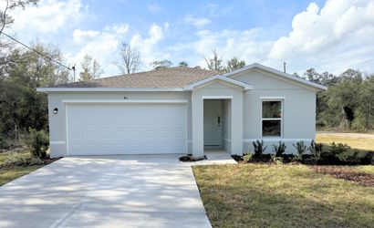 A white house with a garage.