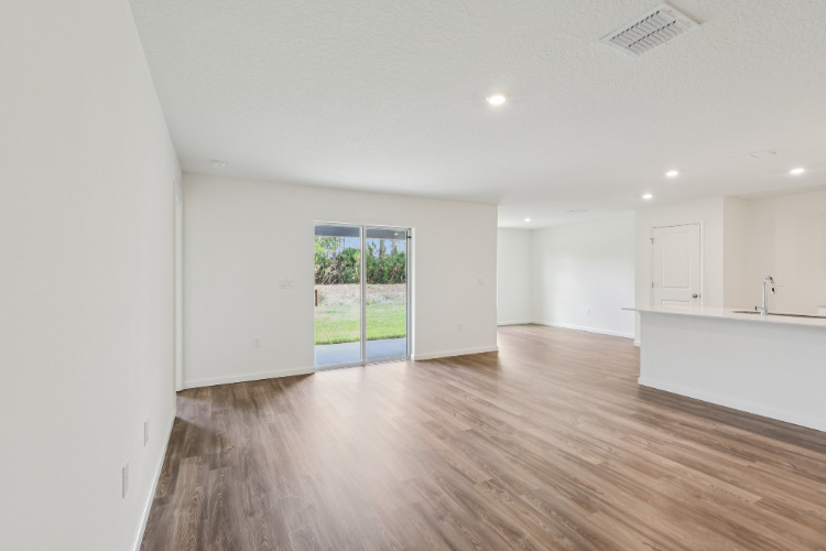 A room with white walls and a wood floor.