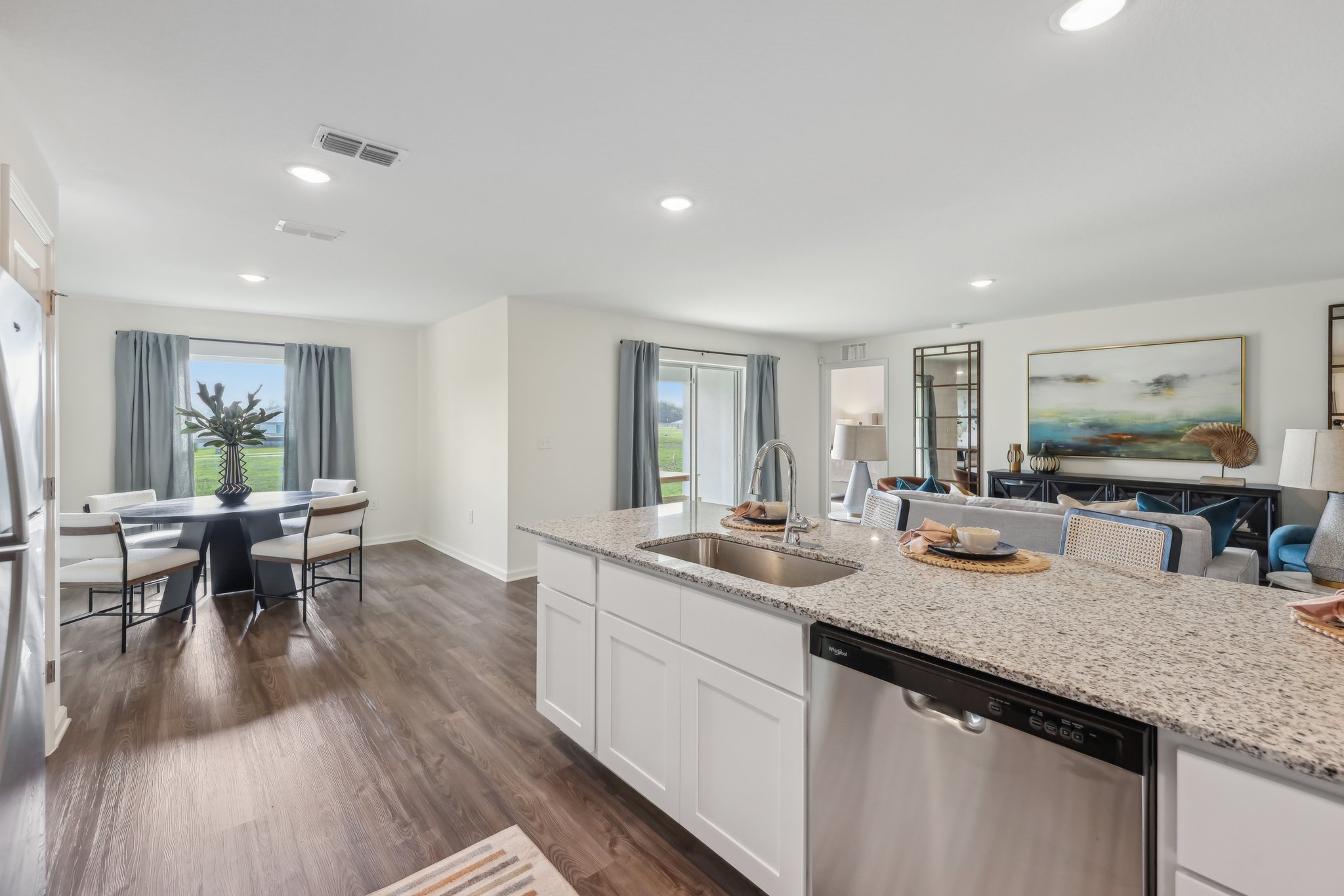 A kitchen with a marble island.