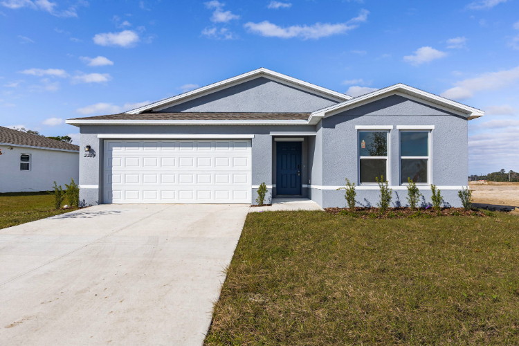 A white house with a driveway.