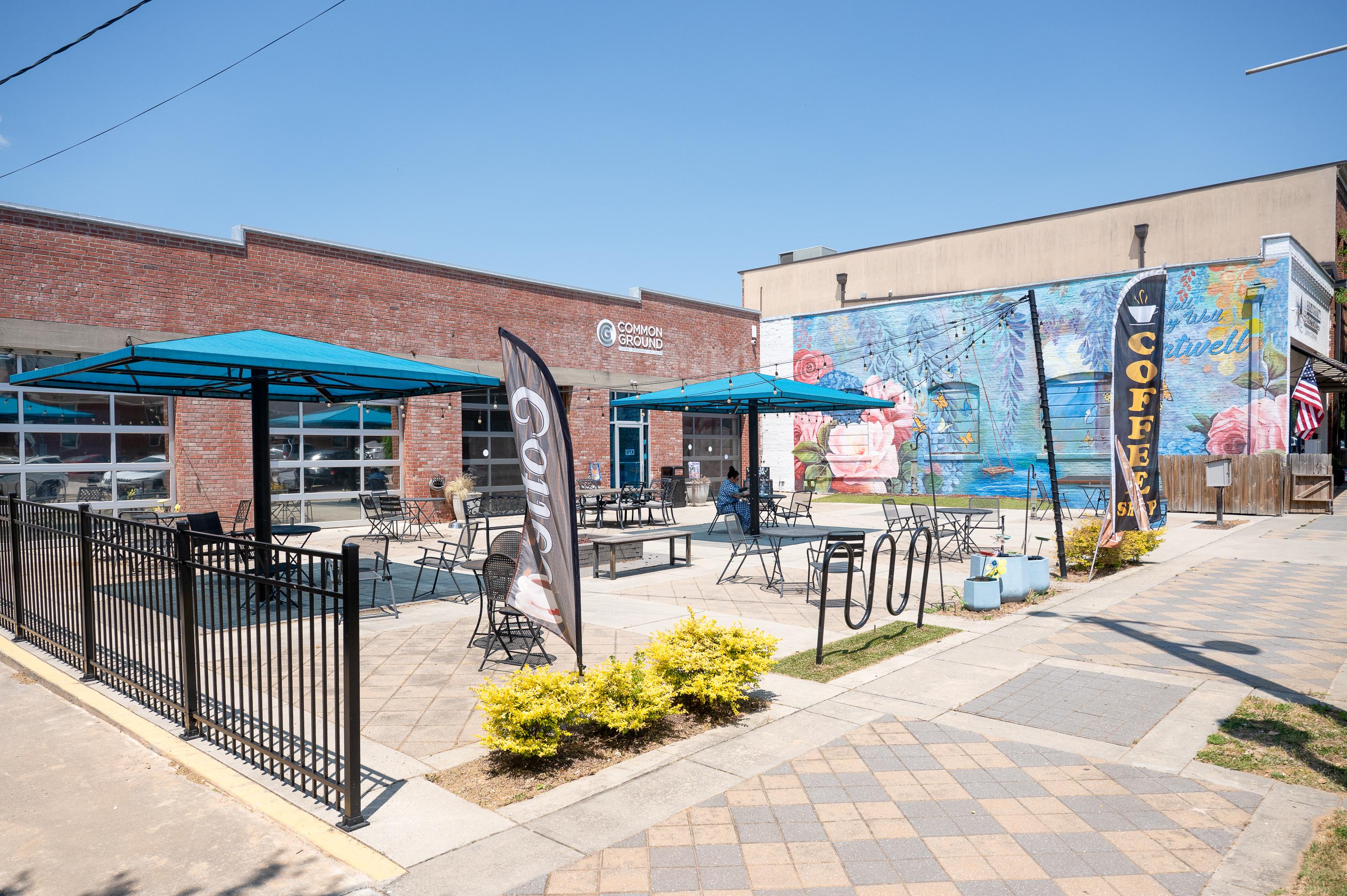 A brick building with tables and chairs.