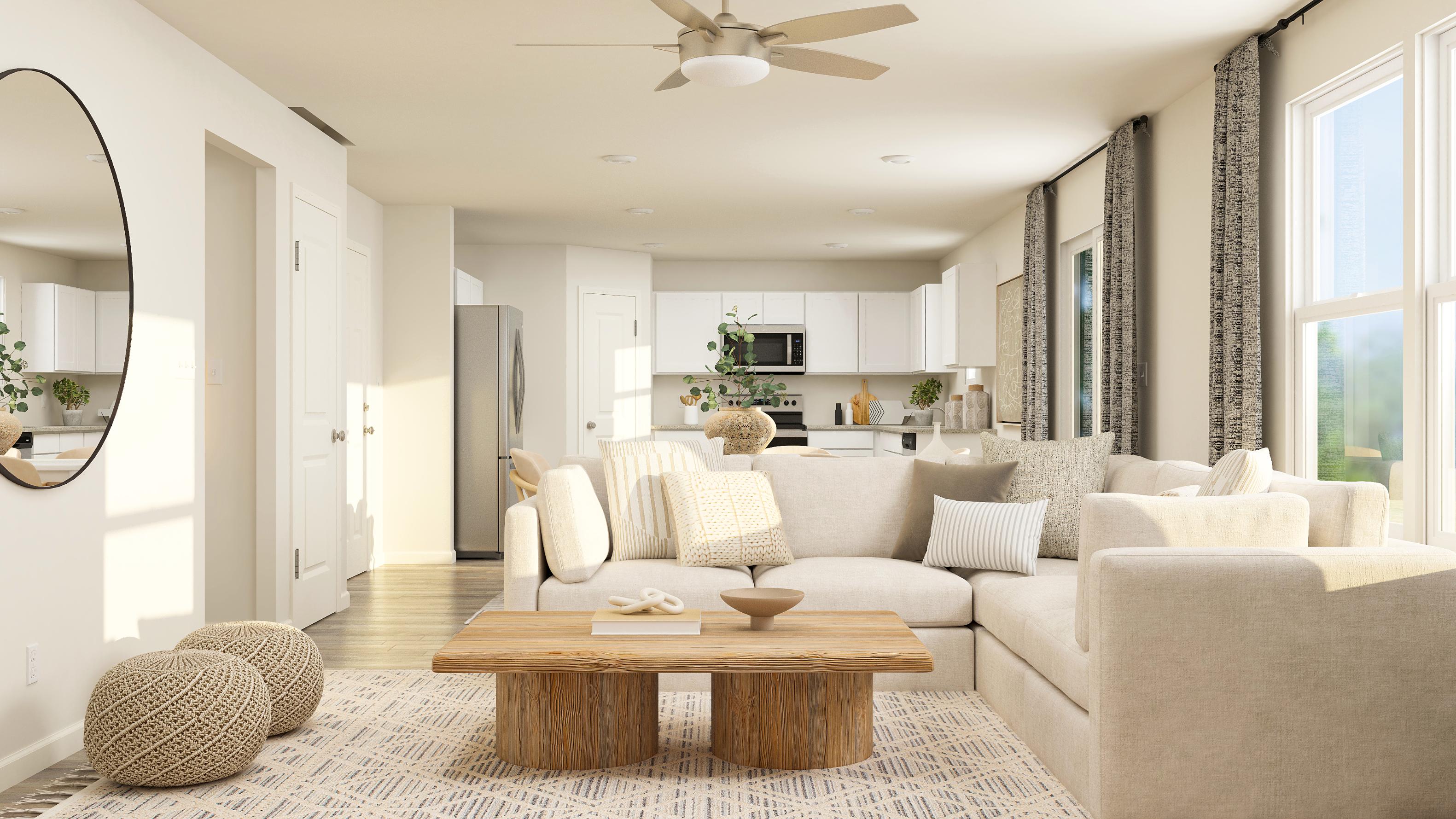 A living room with a large white couch and a table.