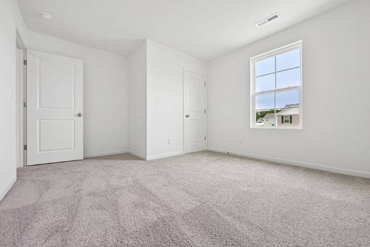 A room with white walls and a window.