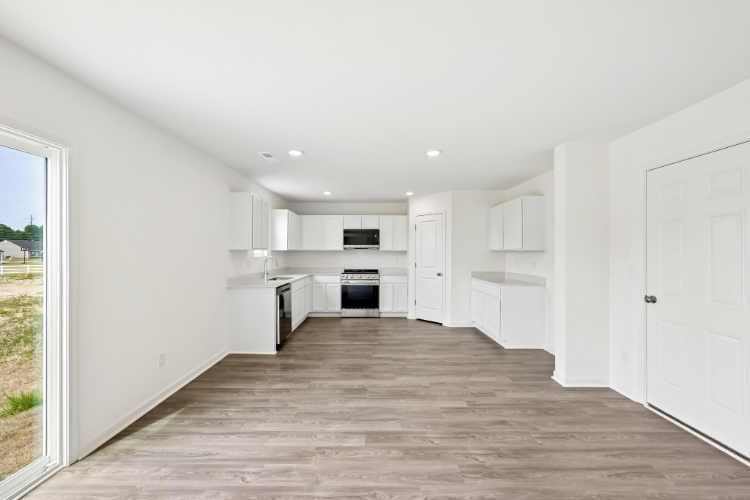 A kitchen with white cabinets.