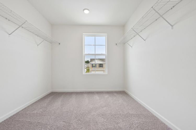 A room with a window and carpet.