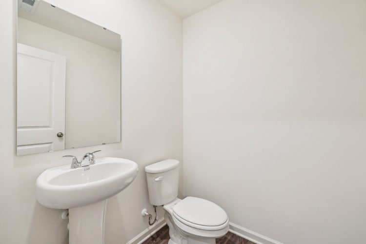 A bathroom with a toilet and sink.